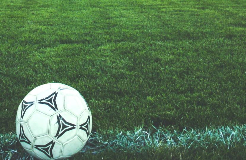 A football in a field depicting childhood lost to smartphones