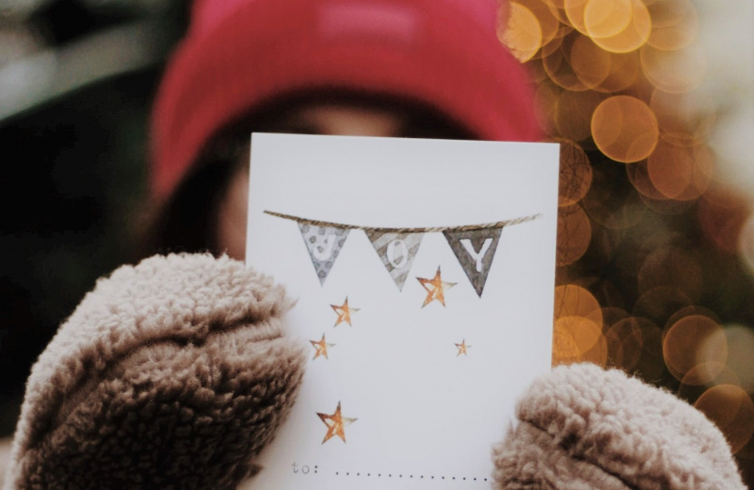 School child holding up a Christmas card, Penistone and Stocksbridge