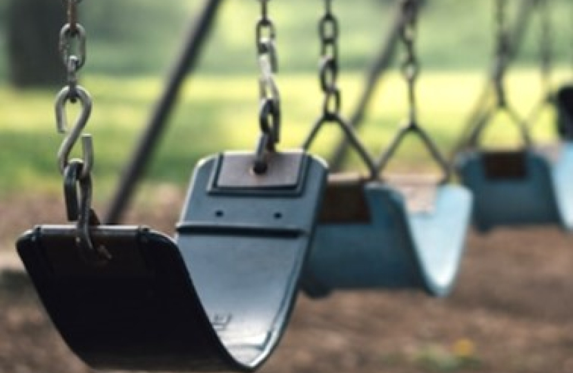 Empty swings suggesting school is closed