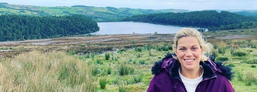 Miriam standing above the river to highlight flood risk