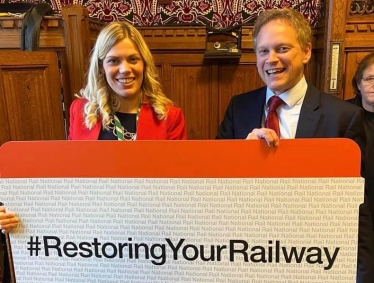 Miriam Cates MP with Grant Shapps holding a giant railway ticket