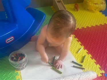 Baby painting representing early years investment