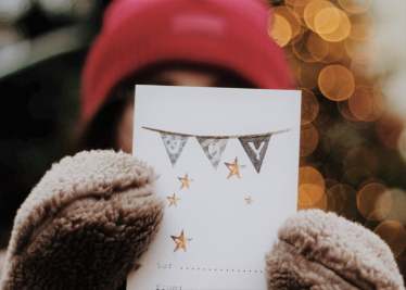 School child holding up a Christmas card, Penistone and Stocksbridge