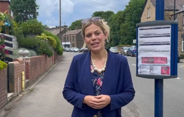 Miriam waiting by a Stocksbridge bus stop